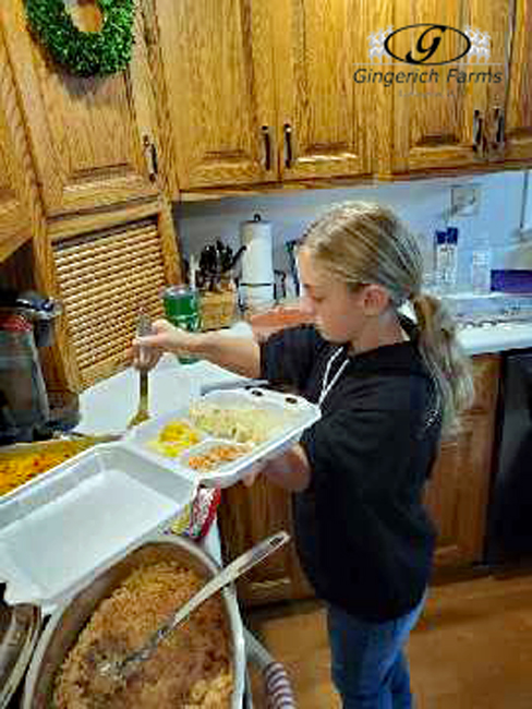 Kylie dishing up dinner - Gingerich Farms